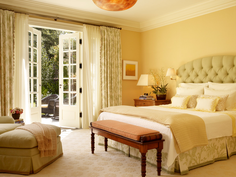 Inspiration for a bedroom in San Francisco with yellow walls, carpet and beige floors.