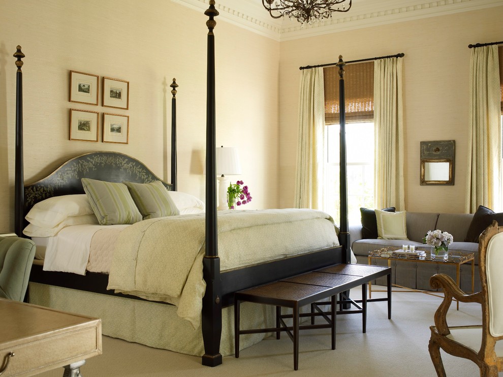 Inspiration for a traditional master bedroom in Houston with beige walls and carpet.