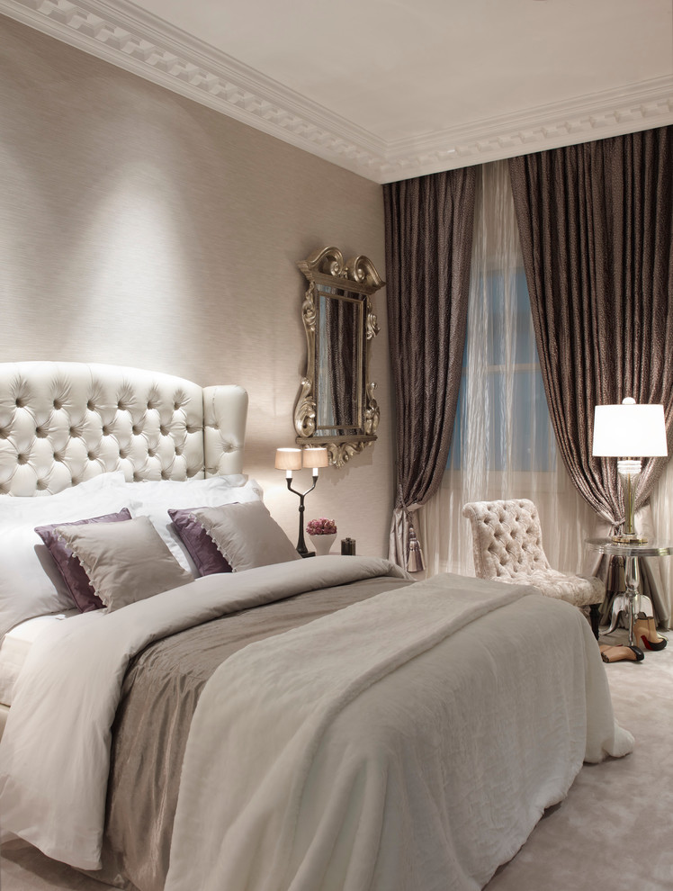 Example of a large classic guest carpeted bedroom design in London with gray walls and no fireplace