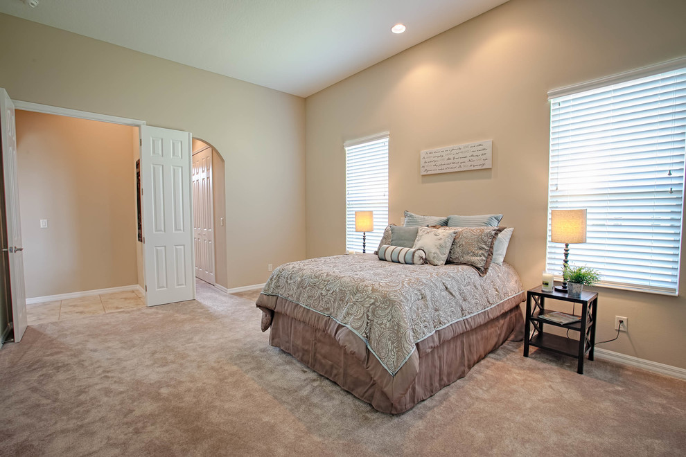 Design ideas for a medium sized classic master bedroom in Orlando with beige walls, carpet and no fireplace.