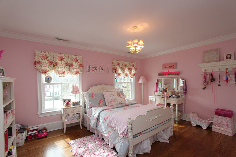 Ejemplo de dormitorio clásico de tamaño medio con paredes rosas, suelo de madera oscura y suelo marrón