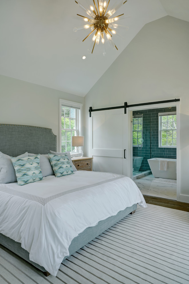 This is an example of a beach style master bedroom in Other.