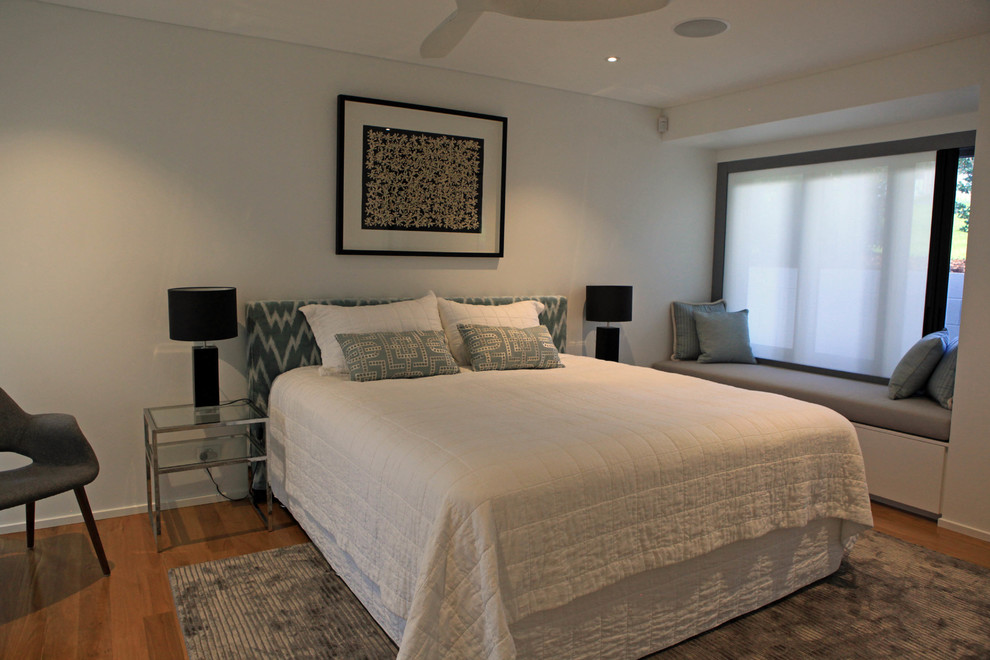 Medium sized modern guest bedroom in Sunshine Coast with white walls.