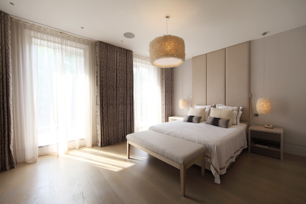 Design ideas for a large contemporary master bedroom in London with beige walls and no fireplace.
