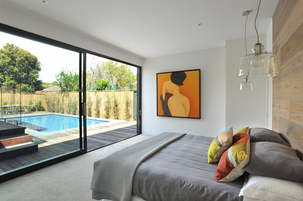 Photo of a contemporary bedroom in Melbourne with white walls, carpet and no fireplace.