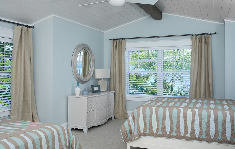 Modelo de habitación de invitados costera grande con paredes azules y moqueta