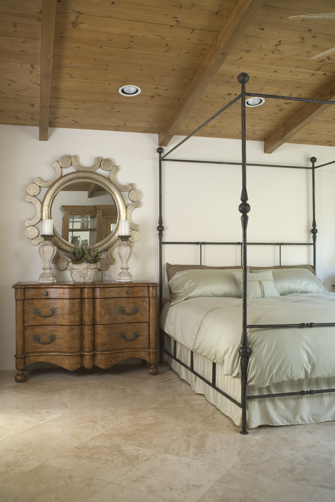 This is an example of a traditional bedroom in San Diego with white walls.