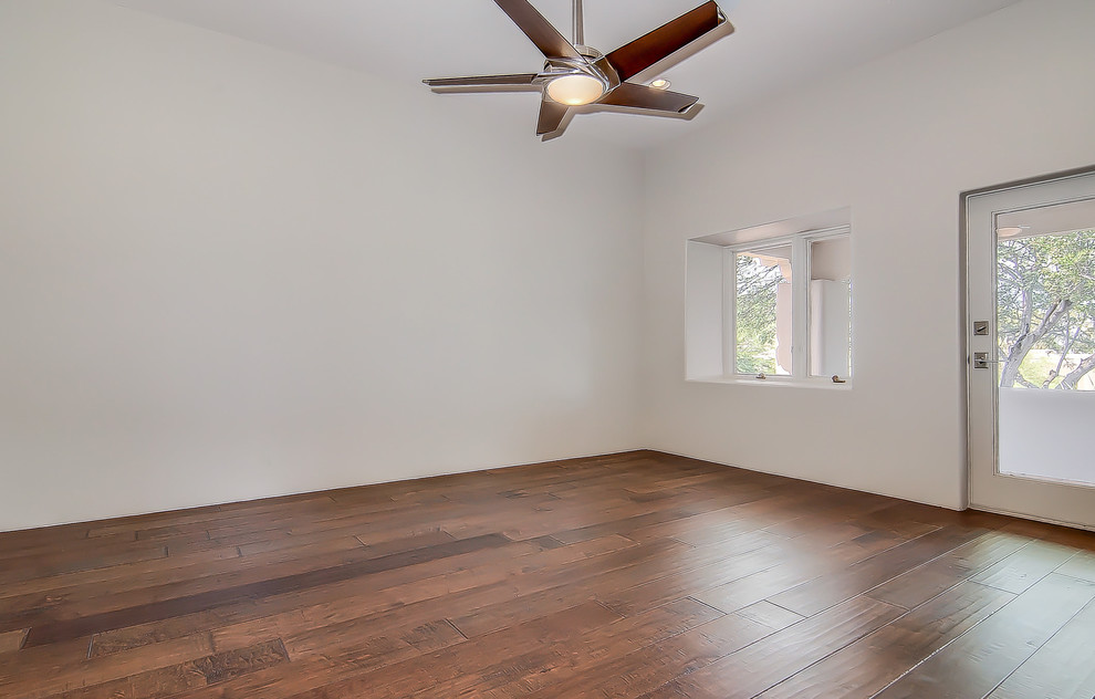 Huge transitional guest medium tone wood floor bedroom photo in Phoenix with no fireplace