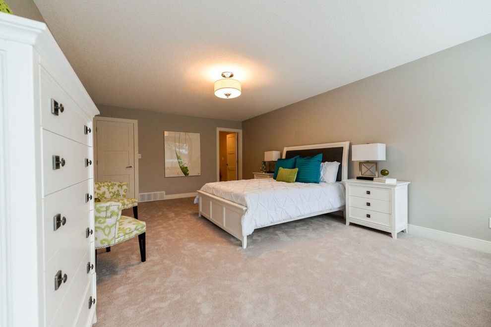 Cette photo montre une grande chambre tendance avec un mur gris, aucune cheminée et un sol beige.