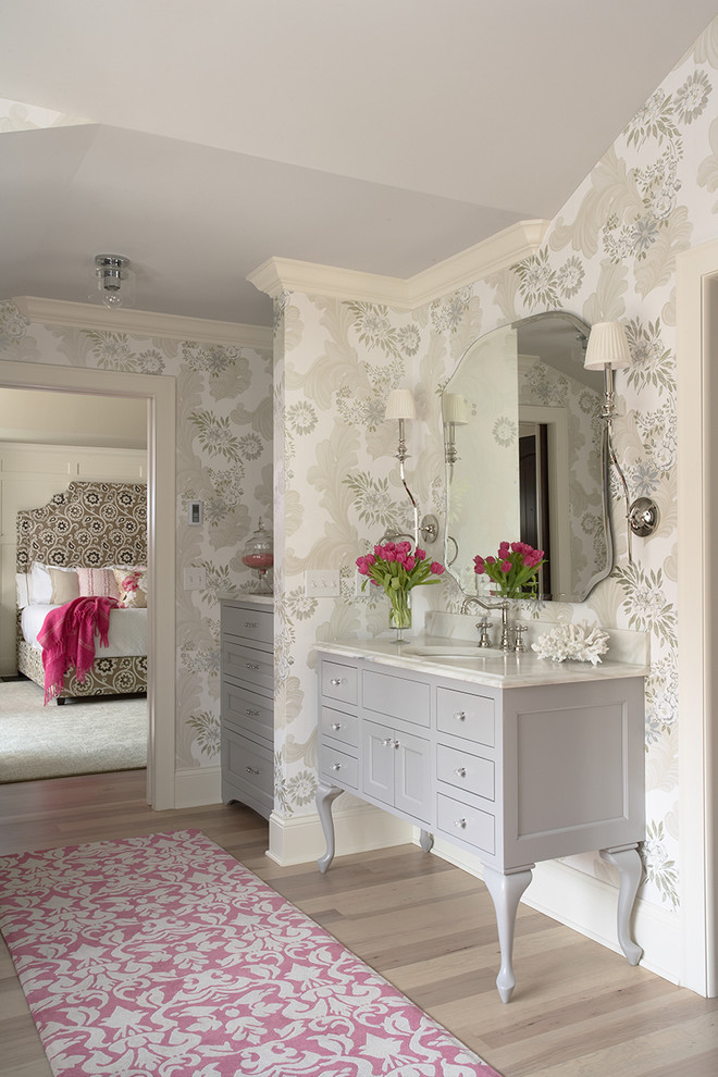 Photo of a traditional grey and cream bedroom in Minneapolis with multi-coloured walls and light hardwood flooring.