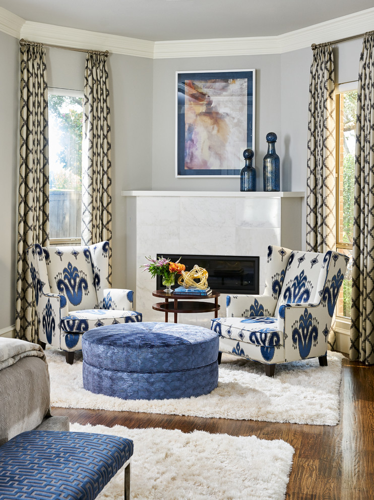 Elegant master medium tone wood floor bedroom photo in Other with gray walls, a stone fireplace and a corner fireplace