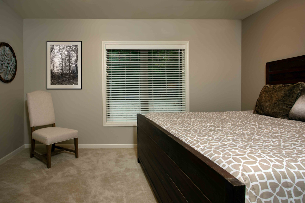 This is an example of a large rustic guest bedroom in Other with beige walls, carpet and beige floors.