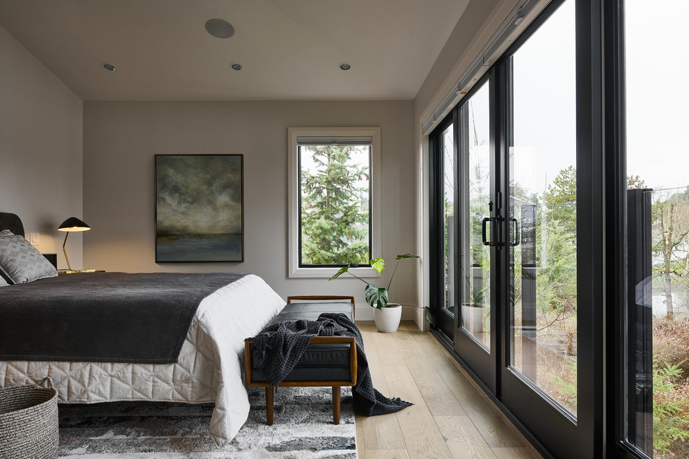 This is an example of a medium sized contemporary master bedroom in Vancouver with light hardwood flooring, beige floors, grey walls and no fireplace.