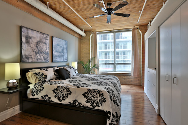 Example of an urban bedroom design in Toronto