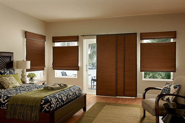 Example of a mid-sized minimalist guest medium tone wood floor bedroom design in Denver with beige walls