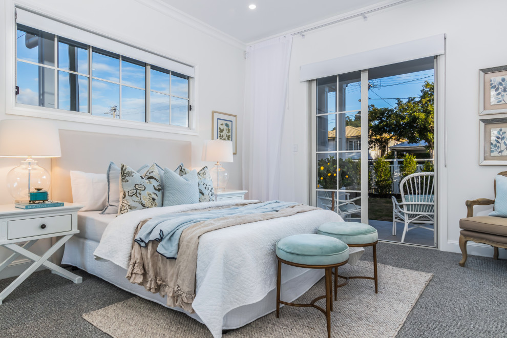 Coastal bedroom in Townsville with white walls, carpet and grey floors.