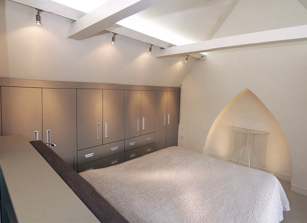 Example of a transitional bedroom design in London