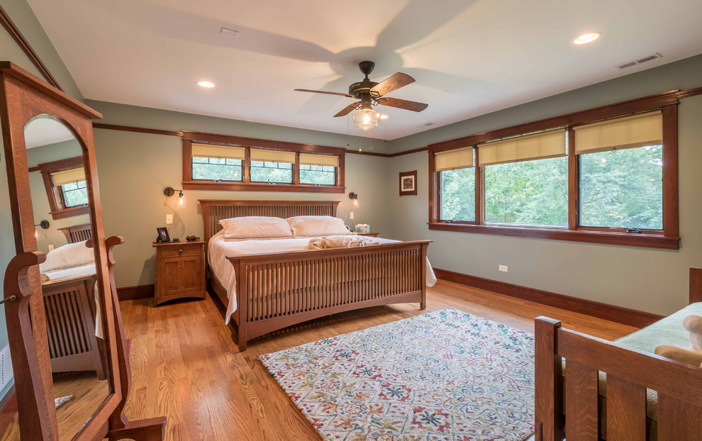 Mid-sized arts and crafts master light wood floor, brown floor, wallpaper ceiling and wallpaper bedroom photo in Chicago with green walls, no fireplace and a tile fireplace