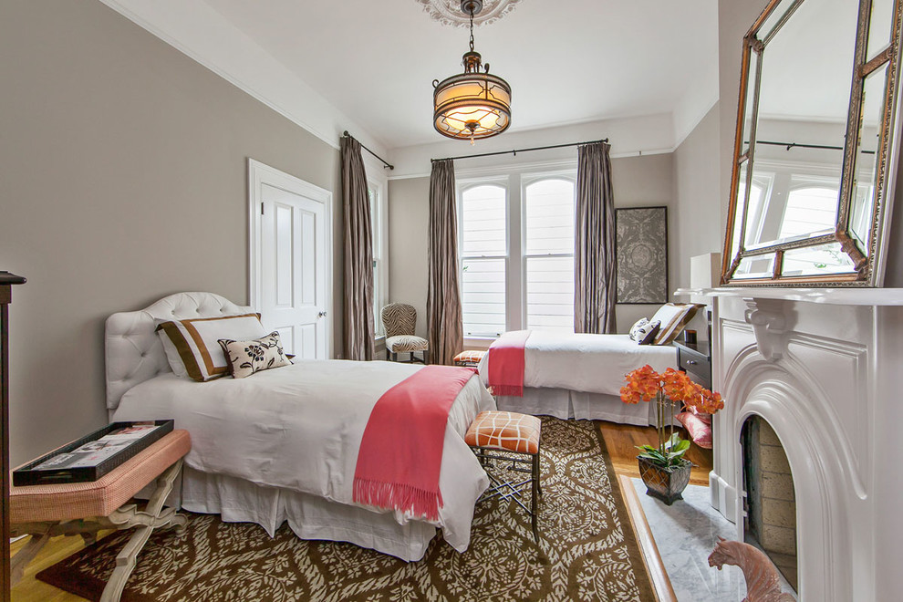 サンフランシスコにある広いトラディショナルスタイルのおしゃれな客用寝室 (茶色い壁、濃色無垢フローリング、標準型暖炉、木材の暖炉まわり、茶色い床)