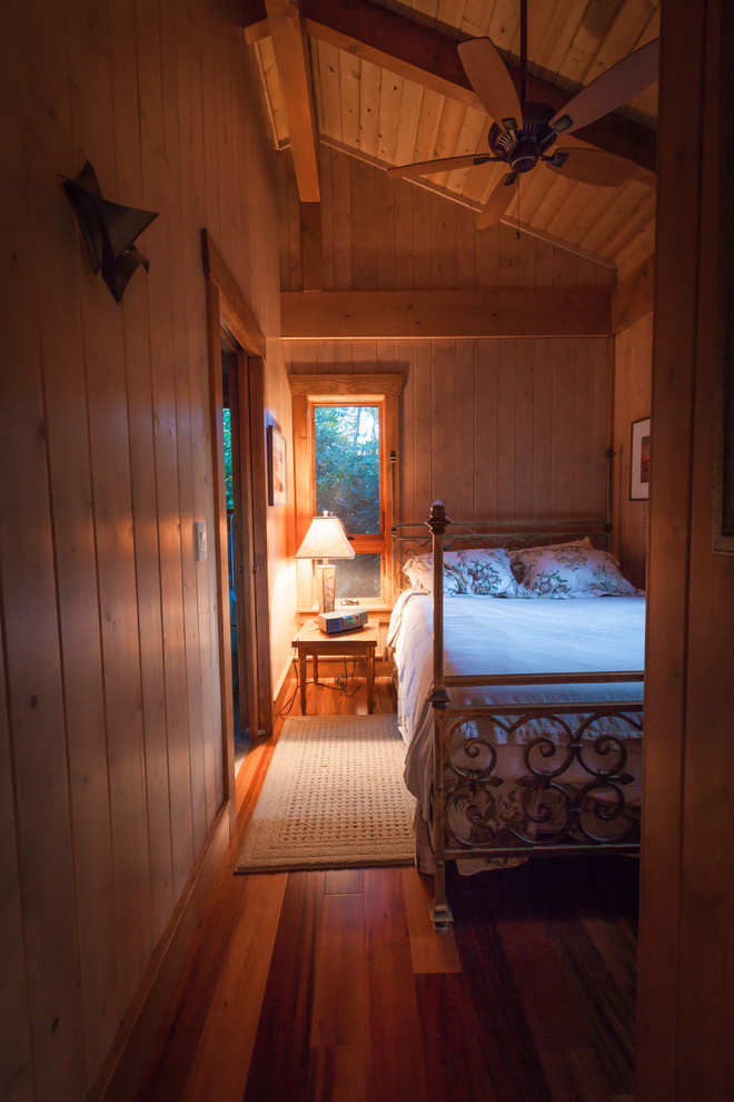 Bedroom - small craftsman guest dark wood floor bedroom idea in Other with brown walls