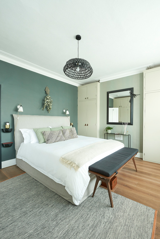 Inspiration for a mid-sized contemporary master light wood floor and beige floor bedroom remodel in London with green walls