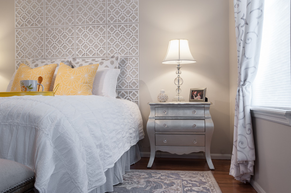 This is an example of a medium sized classic guest bedroom in St Louis with medium hardwood flooring and grey walls.