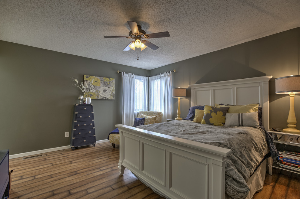 Photo of a medium sized traditional master bedroom in Kansas City with grey walls, medium hardwood flooring and no fireplace.
