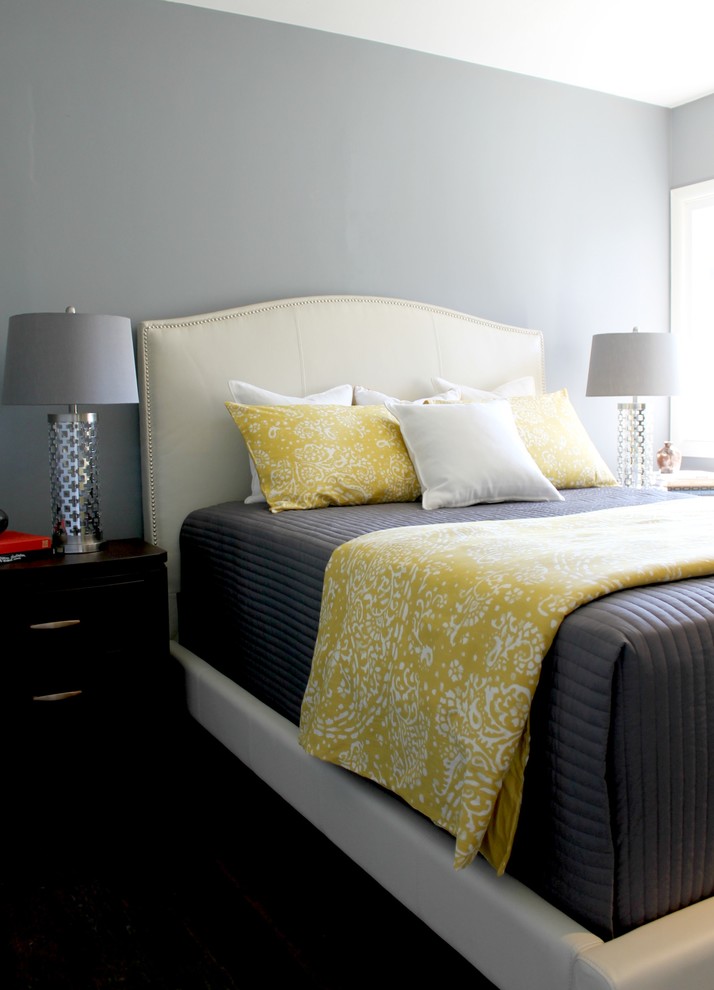 Gray, Yellow and White Bedding on a White Upholstered Bed ...