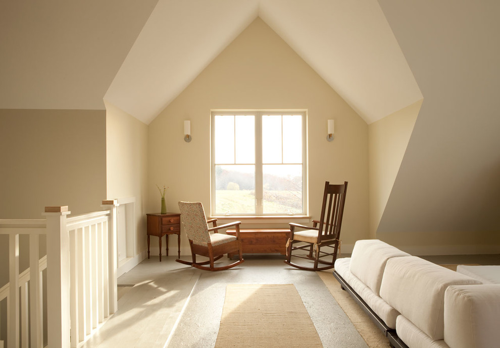 This is an example of a medium sized farmhouse guest bedroom in Portland Maine with beige walls and light hardwood flooring.