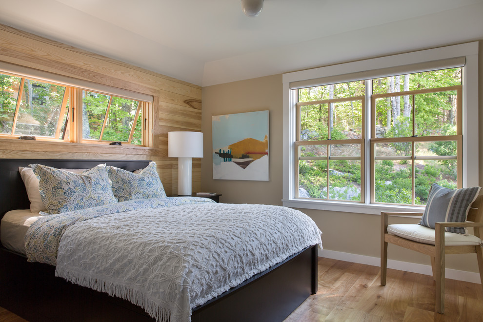 Inspiration for a mid-sized transitional master medium tone wood floor and brown floor bedroom remodel in Portland Maine with beige walls and no fireplace