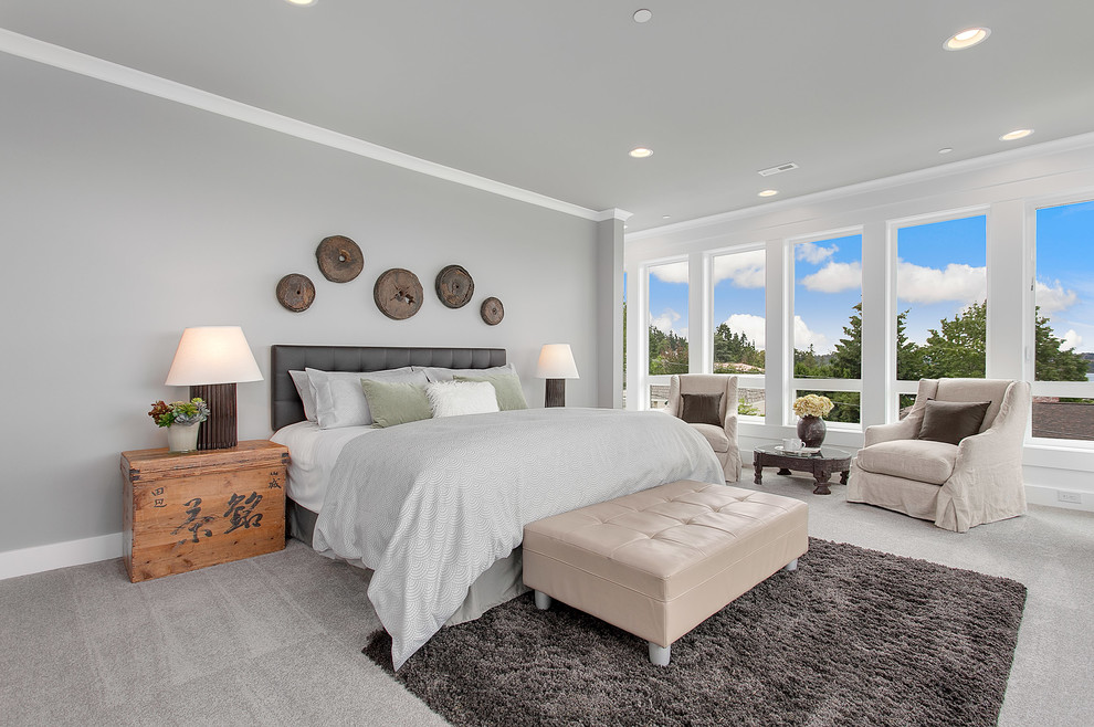 This is an example of an expansive classic master bedroom in Seattle with grey walls, carpet and feature lighting.