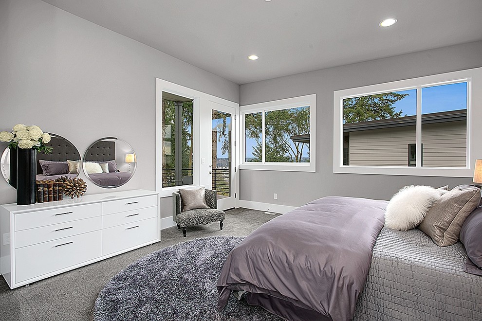 Example of a minimalist master carpeted bedroom design in Seattle with gray walls and no fireplace