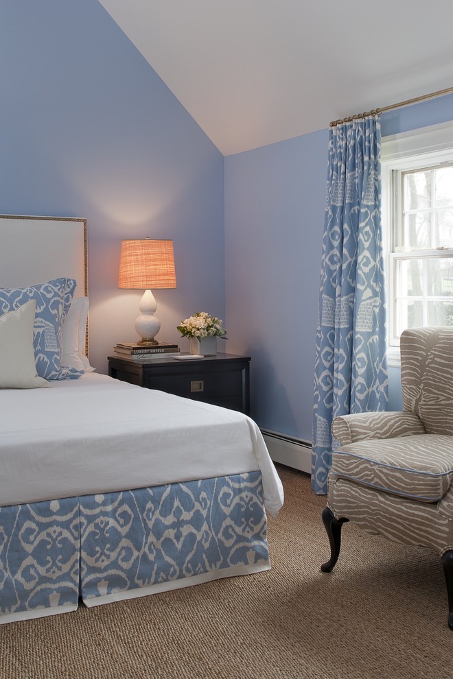Example of a mid-sized classic guest carpeted and beige floor bedroom design in New York with blue walls and no fireplace