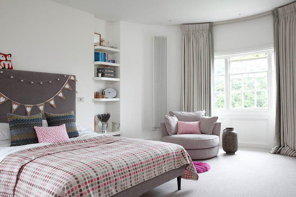 Medium sized contemporary bedroom in London with white walls, carpet and grey floors.