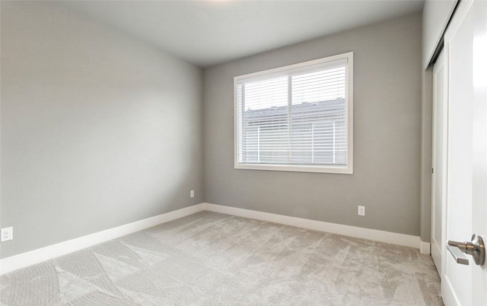 Réalisation d'une chambre avec moquette minimaliste de taille moyenne avec un mur gris et un sol gris.
