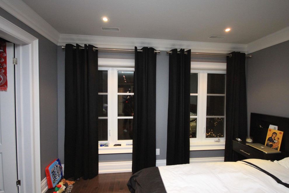 Medium sized modern master and grey and silver bedroom in Toronto with dark hardwood flooring and no fireplace.