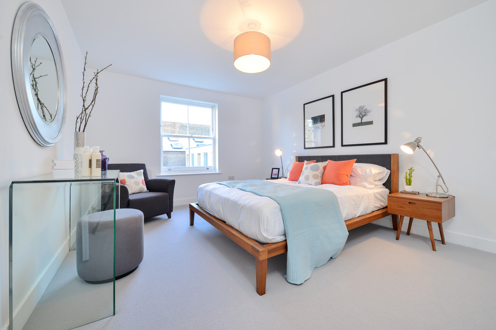 Mid-sized trendy guest carpeted and gray floor bedroom photo in London with white walls