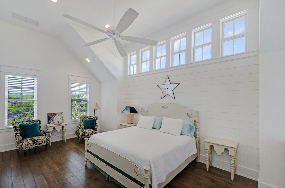 Beach style bedroom in Miami with white walls and dark hardwood flooring.