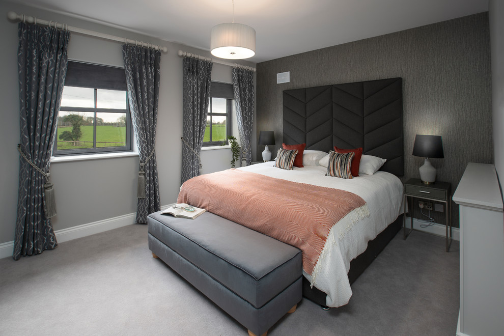 Large trendy guest carpeted and gray floor bedroom photo in Dublin with gray walls