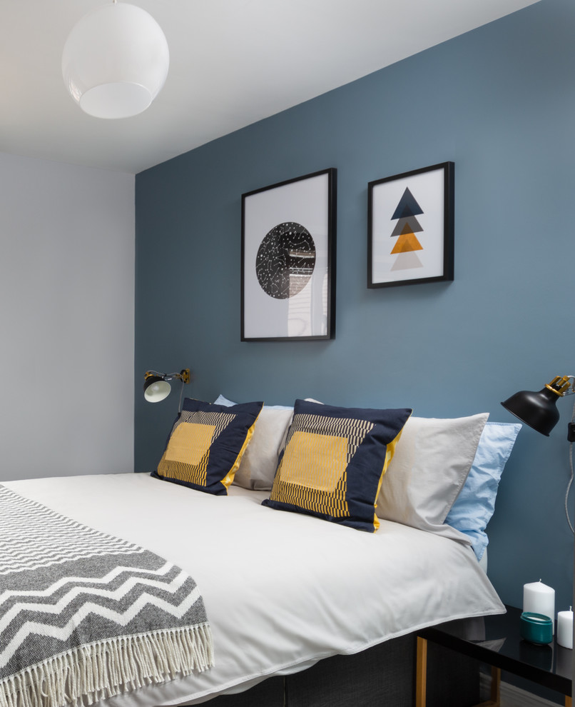 Photo of a small eclectic guest bedroom in Other with grey walls.