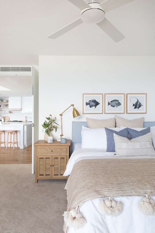 Example of a mid-sized beach style guest carpeted and beige floor bedroom design in Gold Coast - Tweed with white walls