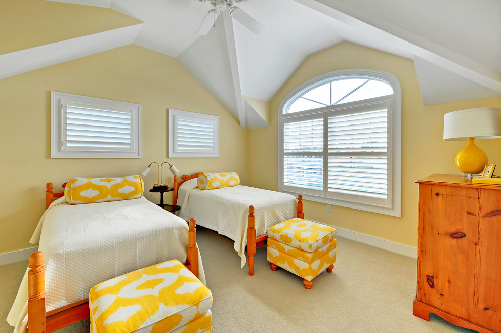 This is an example of a nautical guest bedroom in Philadelphia with yellow walls and carpet.