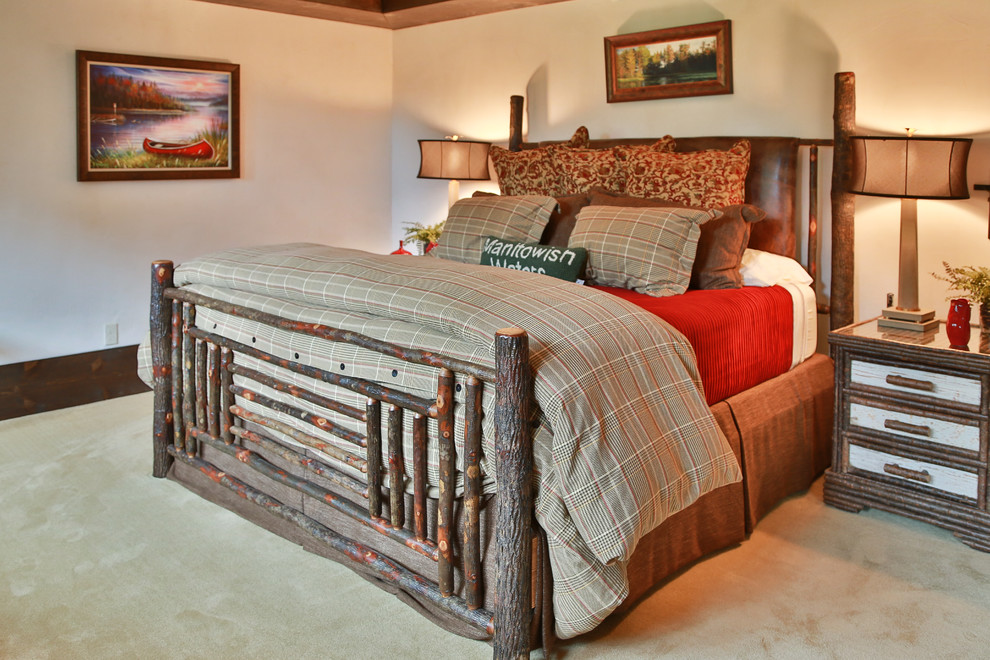 This is an example of a medium sized rustic master bedroom in Other with beige walls, carpet and no fireplace.
