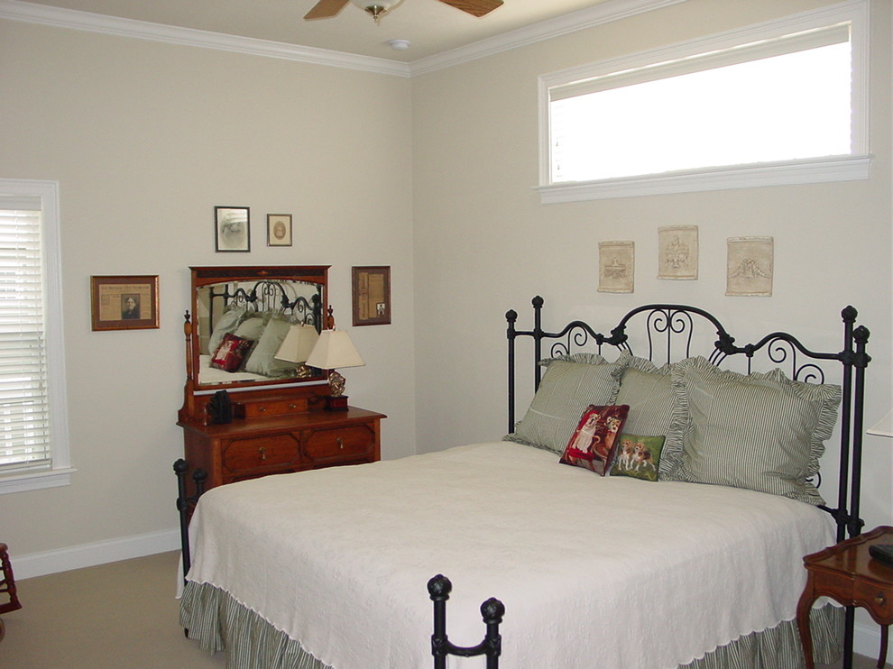 Mid-sized elegant guest carpeted bedroom photo in Miami with beige walls