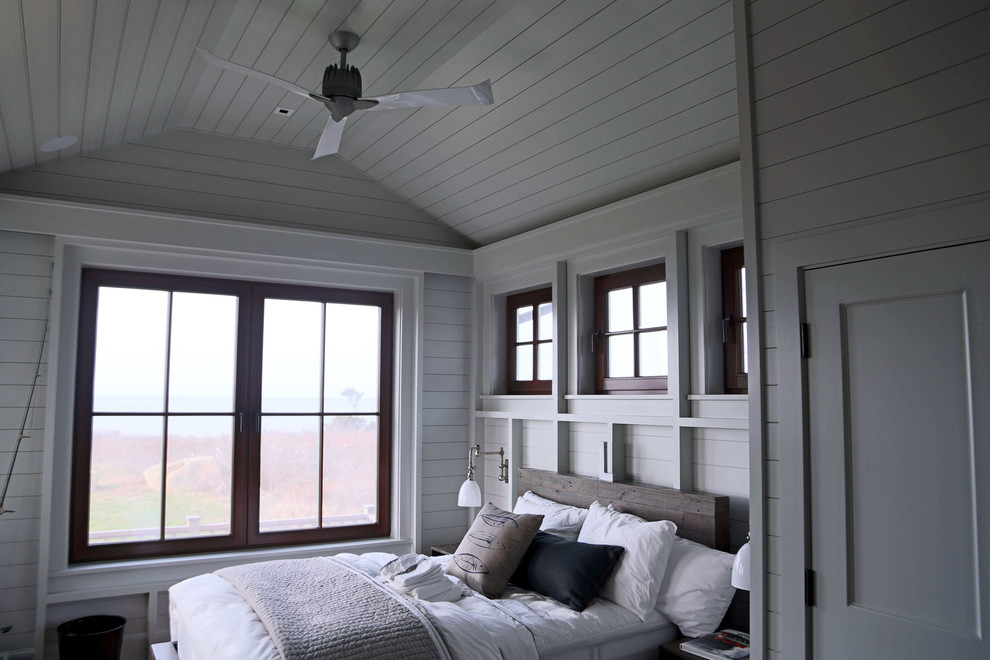 Inspiration for a large beach style guest bedroom in Boston with white walls and medium hardwood flooring.