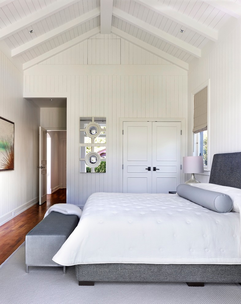 Diseño de habitación de invitados tradicional sin chimenea con paredes blancas y suelo de madera en tonos medios