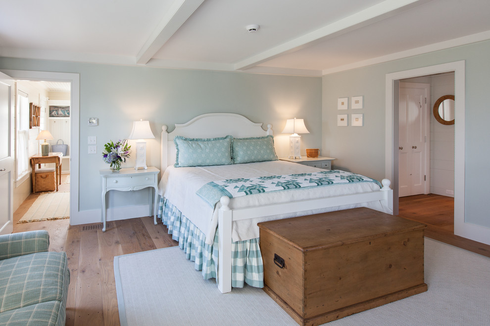 Ejemplo de dormitorio principal costero de tamaño medio con paredes beige y suelo de madera en tonos medios