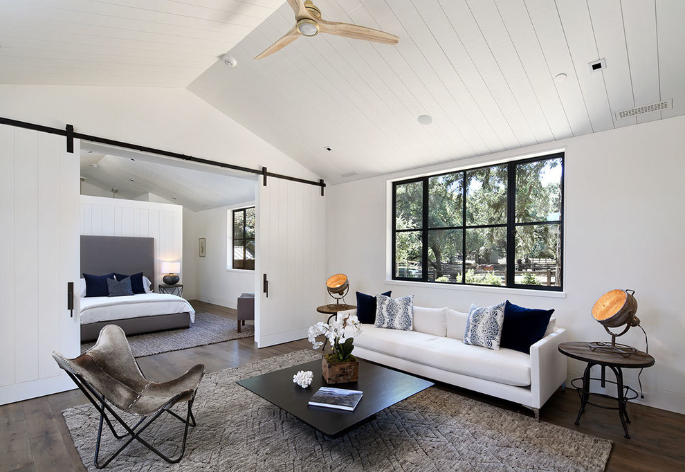 Imagen de habitación de invitados de estilo de casa de campo de tamaño medio con paredes blancas, suelo marrón y suelo de madera en tonos medios