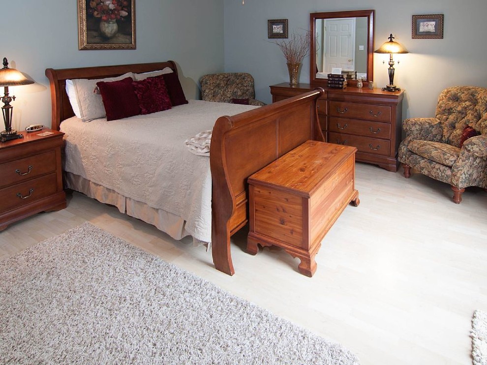 Medium sized classic guest bedroom in DC Metro with grey walls and light hardwood flooring.