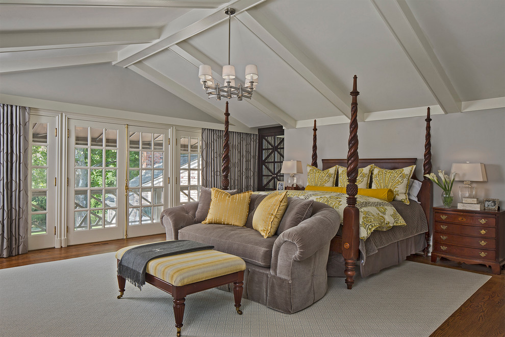 Large traditional master bedroom in Detroit with grey walls and medium hardwood flooring.